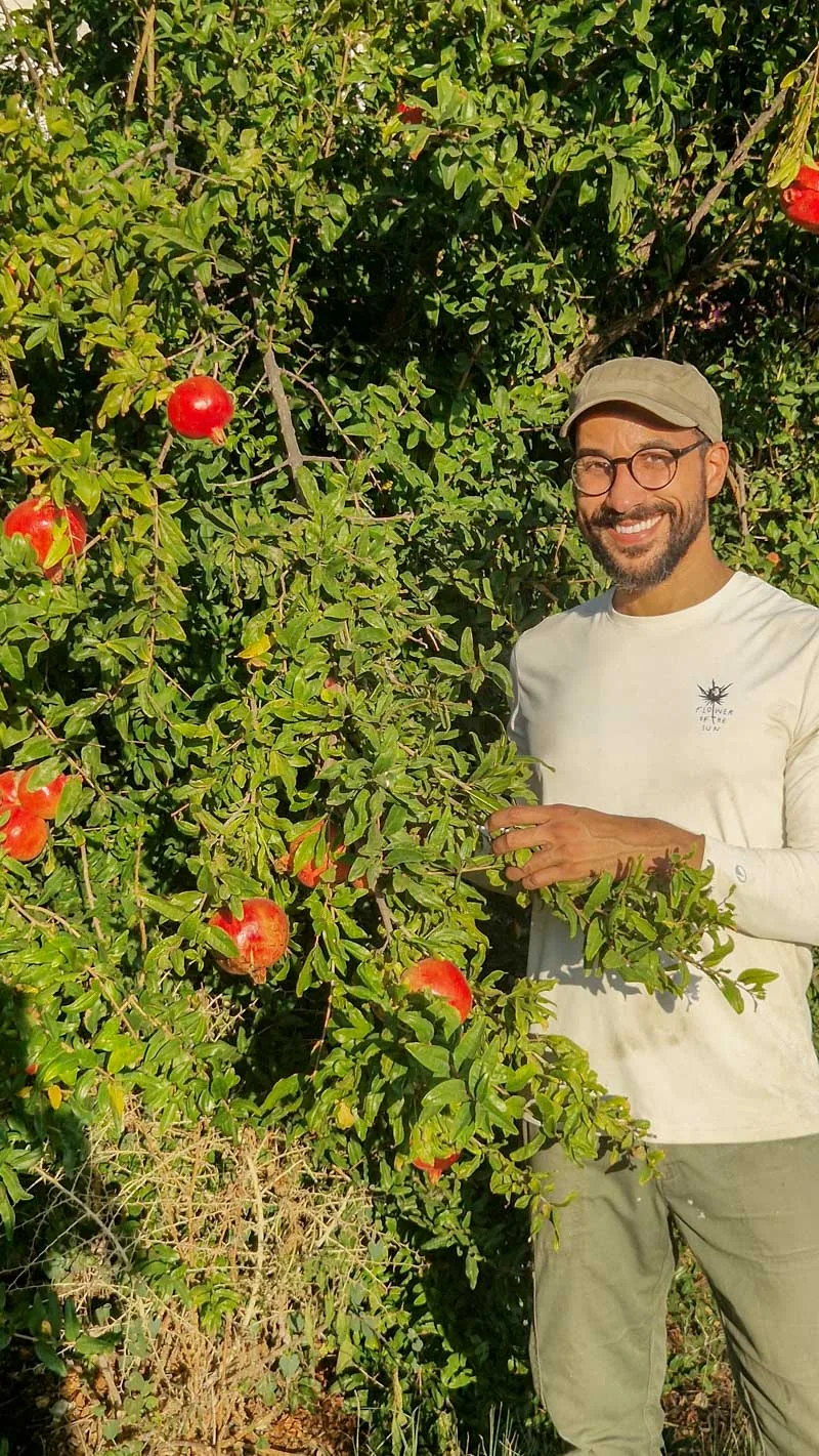 Marcos beside the pomegranate tree
